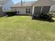 Spacious backyard featuring a lush lawn and a garden with hydrangeas at 2535 Kinglass Dr, Fuquay Varina, NC 27526