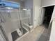 Bright bathroom features a walk-in shower with seating and a closet at 2535 Kinglass Dr, Fuquay Varina, NC 27526