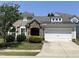 Charming one-story home featuring stone accents, a manicured lawn, and a two-car garage at 2535 Kinglass Dr, Fuquay Varina, NC 27526