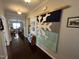 Inviting hallway featuring hardwood floors and a stylish snowflake-themed wall hanging at 2535 Kinglass Dr, Fuquay Varina, NC 27526