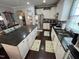 Modern kitchen featuring an island, stainless steel appliances, and dark granite countertops at 2535 Kinglass Dr, Fuquay Varina, NC 27526