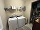 Functional laundry room with washer, dryer, and storage shelving at 2535 Kinglass Dr, Fuquay Varina, NC 27526