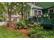 Charming green home exterior with a colorful deck, landscaping, and a purple door at 2724 Glastonbury Rd, Apex, NC 27539
