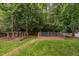 View of backyard featuring fenced areas, and green trees at 2724 Glastonbury Rd, Apex, NC 27539