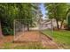 Backyard with large fenced area surrounded by mature trees and lush greenery at 2724 Glastonbury Rd, Apex, NC 27539