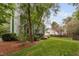 Green two-story home with a well-maintained yard, deck, and surrounding trees at 2724 Glastonbury Rd, Apex, NC 27539