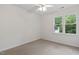 Bright bedroom with neutral carpeting and two large windows at 2724 Glastonbury Rd, Apex, NC 27539