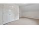 Bright bedroom featuring neutral carpet, white walls, and a closet with bi-fold doors at 2724 Glastonbury Rd, Apex, NC 27539