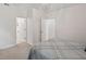 Bright bedroom with neutral carpeting, white trim and walls, and access to other rooms at 2724 Glastonbury Rd, Apex, NC 27539