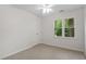 Bright bedroom with neutral carpeting, closet and large window at 2724 Glastonbury Rd, Apex, NC 27539
