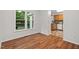 Hardwood dining room flooring that transitions to a tiled kitchen in the next room at 2724 Glastonbury Rd, Apex, NC 27539