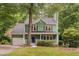 Charming two-story green home with a covered front porch and a well-manicured lawn at 2724 Glastonbury Rd, Apex, NC 27539