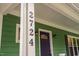 Exterior view of the house number on a white pillar, accenting the green siding at 2724 Glastonbury Rd, Apex, NC 27539