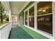 Inviting front porch featuring green painted wood floors and white railings at 2724 Glastonbury Rd, Apex, NC 27539