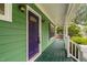 Charming front porch with green siding and a vibrant purple front door at 2724 Glastonbury Rd, Apex, NC 27539