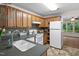 Functional kitchen with light wood cabinets, a neutral countertop, and open shelving nearby at 2724 Glastonbury Rd, Apex, NC 27539