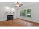 Bright living room featuring a decorative fireplace and ample natural light at 2724 Glastonbury Rd, Apex, NC 27539