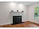 Living room featuring a decorative fireplace and neutral walls at 2724 Glastonbury Rd, Apex, NC 27539