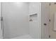 Walk-in shower featuring subway tile and niche at 2724 Glastonbury Rd, Apex, NC 27539