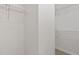 A walk-in closet with ample shelving for storage and tiled flooring at 2724 Glastonbury Rd, Apex, NC 27539