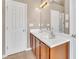 Well-lit bathroom with double sink vanity and white cabinets, offering ample storage at 3027 Courtney Creek Blvd, Durham, NC 27713