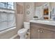 Well-lit powder room features a modern vanity, toilet, decorative mirrors, and a large window at 3027 Courtney Creek Blvd, Durham, NC 27713