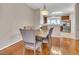Inviting dining room with wood floors, a stylish table, upholstered chairs, and a chandelier at 3027 Courtney Creek Blvd, Durham, NC 27713