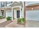 Inviting front entrance features a black door, manicured bushes, and a well-maintained lawn at 3027 Courtney Creek Blvd, Durham, NC 27713