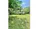 A spacious grassy yard and home with a single door entry at 304 Sandalwood Ave, Louisburg, NC 27549