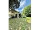 Back of home with screened in porch, grill, and outdoor seating on a grassy lot at 304 Sandalwood Ave, Louisburg, NC 27549