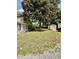 Tranquil backyard with mature trees and a storage shed adjacent to the house at 304 Sandalwood Ave, Louisburg, NC 27549