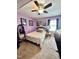 Cozy bedroom with lavender walls, carpeted floor, ceiling fan, and comfortable furnishings at 304 Sandalwood Ave, Louisburg, NC 27549