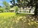 Inviting one-story home with a cozy front yard with mature trees and shrubs at 304 Sandalwood Ave, Louisburg, NC 27549