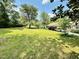 Well-maintained home with a carport, surrounded by a lush, expansive yard with mature trees at 304 Sandalwood Ave, Louisburg, NC 27549
