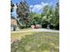View of the home's exterior, including a driveway, truck, and small storage sheds at 304 Sandalwood Ave, Louisburg, NC 27549