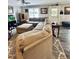 Cozy living room featuring a plush sectional sofa, lots of windows and stylish decor at 304 Sandalwood Ave, Louisburg, NC 27549