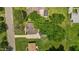 Aerial view of the property showcasing a spacious backyard, mature trees, and a detached garage at 305 Oakgrove Dr, Graham, NC 27253