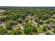 The aerial view shows a neighborhood with mature trees, well-maintained lawns, and various home styles at 305 Oakgrove Dr, Graham, NC 27253