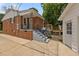 The backyard entrance shows the brick home and gray steps leading up to the back door, plus a detached white garage at 305 Oakgrove Dr, Graham, NC 27253