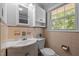 Traditional bathroom with vanity, white sink and patterned tile at 305 Oakgrove Dr, Graham, NC 27253