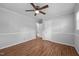 The bedroom features light grey walls, wood floors and a ceiling fan at 305 Oakgrove Dr, Graham, NC 27253