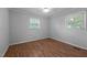 Bright bedroom with new plank flooring, neutral paint, and multiple windows at 305 Oakgrove Dr, Graham, NC 27253