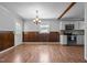 Inviting dining area with wood floors, natural light, and seamless connection to the kitchen area, great for entertaining at 305 Oakgrove Dr, Graham, NC 27253