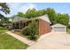 A beautiful home with a detached garage, a well-manicured lawn, and lovely landscaping at 305 Oakgrove Dr, Graham, NC 27253