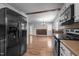 Bright and open kitchen with stainless steel appliances, wood floors, providing an inviting space for cooking and dining at 305 Oakgrove Dr, Graham, NC 27253