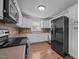 Well-appointed kitchen featuring stainless steel appliances, modern fixtures, white cabinets, and ample counter space at 305 Oakgrove Dr, Graham, NC 27253