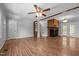 Inviting living area with stylish hardwood floors, a brick fireplace, and cozy ceiling fan at 305 Oakgrove Dr, Graham, NC 27253