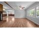 Spacious living room with natural light and hardwood floors, ceiling fan, offering a welcoming and airy atmosphere at 305 Oakgrove Dr, Graham, NC 27253