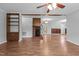 Open living space featuring a brick fireplace, wood beam, and hardwood floors, perfect for Gathering gatherings at 305 Oakgrove Dr, Graham, NC 27253