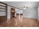 Open-concept living room showcasing a cozy fireplace, built-in shelving, and hardwood floors that connect the spaces at 305 Oakgrove Dr, Graham, NC 27253